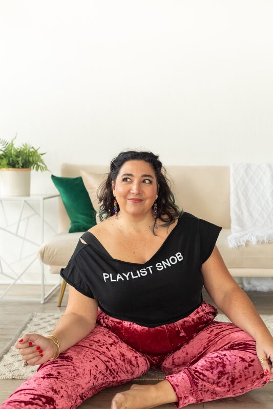 Alexandria seated on the floor, hand on knee, at ease
