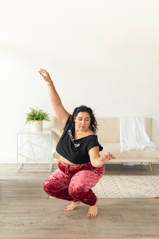 Alexandria mid-motion, one arm reaching upward