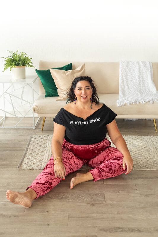 Alexandria seated on couch, cross-legged, smiling