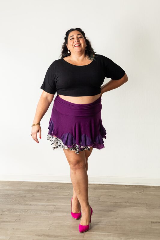 Alexandria standing, hands on hips, confident stance